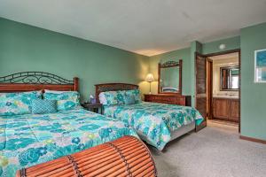a bedroom with two beds and a bench in it at 1 Mi to Shops and Dining Idyllic Lakeside Getaway! in Osage Beach +16 photos