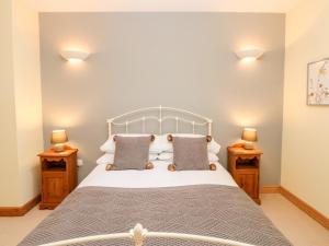 a bedroom with a bed with two night stands at 2 Colby House Barn in Colby