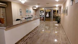 a hotel lobby with a reception counter and a lobby at Hotel Admiral in Vinkovci