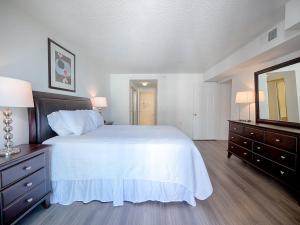a large bedroom with a white bed and a mirror at National at Courthouse Place in Arlington