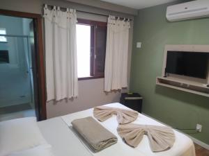 Cama ou camas em um quarto em Pousada Falls Park