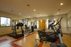 a gym with treadmills and exercise bikes in a room at Blue Tree Towers Fortaleza Beira Mar in Fortaleza