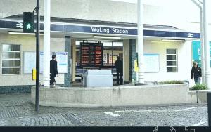 a waiting station with people standing outside of it at New Central Woking 1 and 2 Bedroom Apartments with Free Gym, close to Train Station in Woking