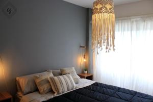 a bedroom with a bed and a chandelier at Rincón Tigre in Tigre