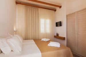 Ένα ή περισσότερα κρεβάτια σε δωμάτιο στο To Rantevou tis Alykis Rooms & Apartments
