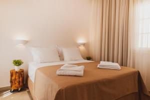 Ένα ή περισσότερα κρεβάτια σε δωμάτιο στο To Rantevou tis Alykis Rooms & Apartments