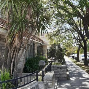 a house with a fence next to a street at Casa Garay 602 in Mar del Plata