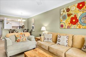 a living room with a couch and a painting on the wall at Unit 3127 - Ocean & Racquet Club in Saint Augustine Beach