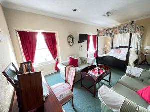a living room with a couch and a bed at White Court Llandudno in Llandudno