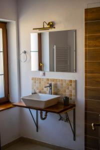 a bathroom with a sink and a mirror at Pensiune agroturistica Casa cu Povesti Rau Sadului in Rau Sadului +33 photos