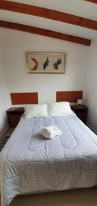 a bedroom with a white bed with a towel on it at Club de Campo Alto Copiapó in Piedra Colgada