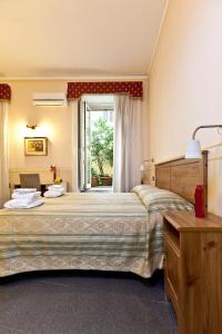 a bedroom with two beds and a large window at B&B MediNaples in Naples