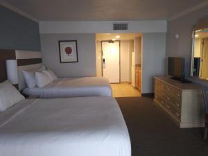 a hotel room with two beds and a television at Ocean Reef Resort in Myrtle Beach