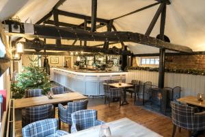 un restaurante con mesas y sillas y un bar en Cantley House Hotel - Wokingham, en Wokingham