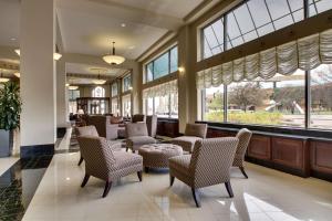 a living room filled with furniture and a large window at Drury Plaza Hotel Broadview Wichita in Wichita