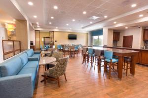 a lobby with a bar and tables and chairs at Drury Inn & Suites St. Louis Brentwood in Brentwood