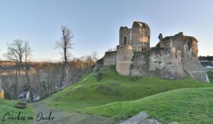an old castle on top of a grassy hill at La maison de Conches in Conches-en-Ouche +9 photos