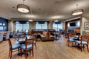 a restaurant with tables and chairs and a couch at Drury Inn & Suites Knoxville West in Knoxville