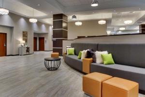 a lobby of a hospital with a couch and chairs at Drury Plaza Hotel Dallas Richardson in Richardson