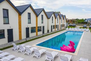 a swimming pool with lounge chairs and a resort at Amber Resort in Rewal