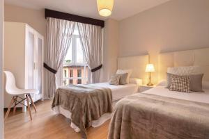 Posteľ alebo postele v izbe v ubytovaní Exclusive Apartments Plaza Merced