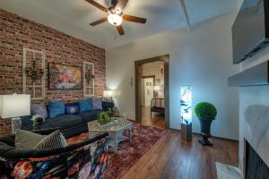 a living room with a couch and a brick wall at The Clinkscale in Jerome