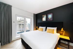 a bedroom with a large bed and a large window at Staycity Aparthotels, Dublin, Christchurch in Dublin