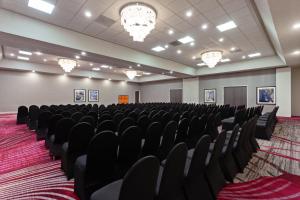 an empty room with black chairs and chandeliers at Crowne Plaza Silicon Valley North - Union City by IHG in Union City +25 photos