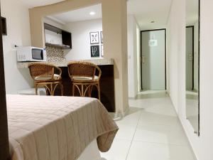 um quarto de hotel com uma cama e uma cozinha em Pipa's Bay Apto 208 - Flat em Pipa RN em Pipa