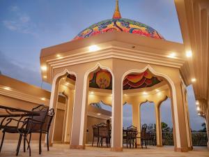 a gazebo with tables and chairs in a building at Dharma Beach in Montañita