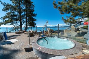 a hot tub in a circle with trees and water at Red Wolf Lakeside Lodge in Tahoe Vista