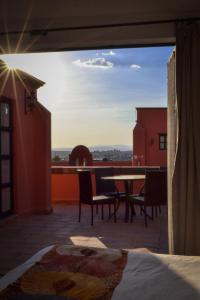 a view of a patio with a table and chairs at Hotel Casa Rosada - Adults Only in San Miguel de Allende