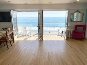 a living room with a view of the ocean at Malibu Private Beach Apartments in Malibu