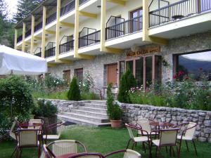 a group of tables and chairs in front of a building at Valia Calda Hotel in Perivoli +46 photos