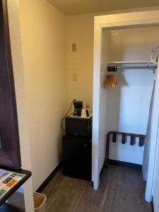 a small room with a kitchen with a stove in it at Extend-a-Suites Tempe in Tempe