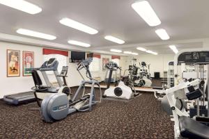 a gym with treadmills and elliptical machines at Travelodge by Wyndham Clinton Valley West Court in Clinton