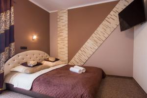 a bedroom with a large bed with a brick wall at Willa Bustryk in Bustryk +115 photos