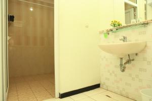 a bathroom with a sink and a shower at Arya Graha Semarang in Semarang
