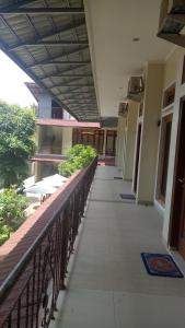 a hallway of a building with a balcony at Djembar Inn in Kalasan