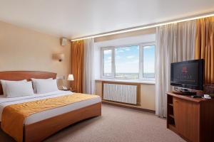 a hotel room with a bed and a television at AZIMUT Hotel Nizhniy Novgorod in Nizhny Novgorod