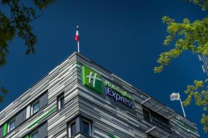 a building with a flag on top of it at Holiday Inn Express Strasbourg Centre by IHG in Strasbourg