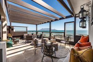 a living room with a view of the ocean at Belle Maroc in Bloubergstrand