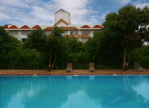 a large swimming pool in front of a hotel at Sarovar Portico Gir in Sasan Gir