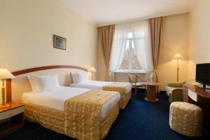 Postel nebo postele na pokoji v ubytování Ramada by Wyndham Plovdiv Trimontium
