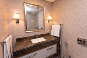 a bathroom with a sink and a mirror at Maslak Aparts in Istanbul