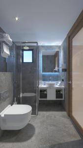 a bathroom with a shower and a toilet and a sink at Panorama Hotel - All Inclusive in Alanya