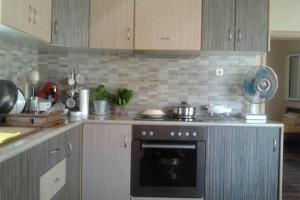 a kitchen with a stove and a counter top at Kalloni Village House in Kalloni