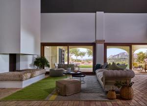 a living room with a couch and a table at Cascioni Eco Retreat in Arzachena