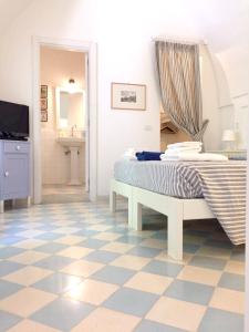 セルヴァ・ディ・ファザーノにある2 bedrooms appartement with shared pool and wifi at Selva di Fasano 9 km away from the beachのチェックフロアのベッドルーム1室(ベッド1台付)