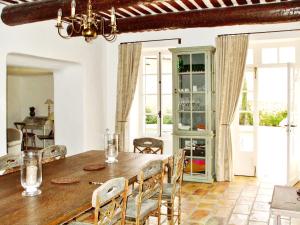 a dining room with a wooden table and chairs at Maison de 4 chambres avec piscine privee jardin amenage et wifi a Molleges in Mollégès